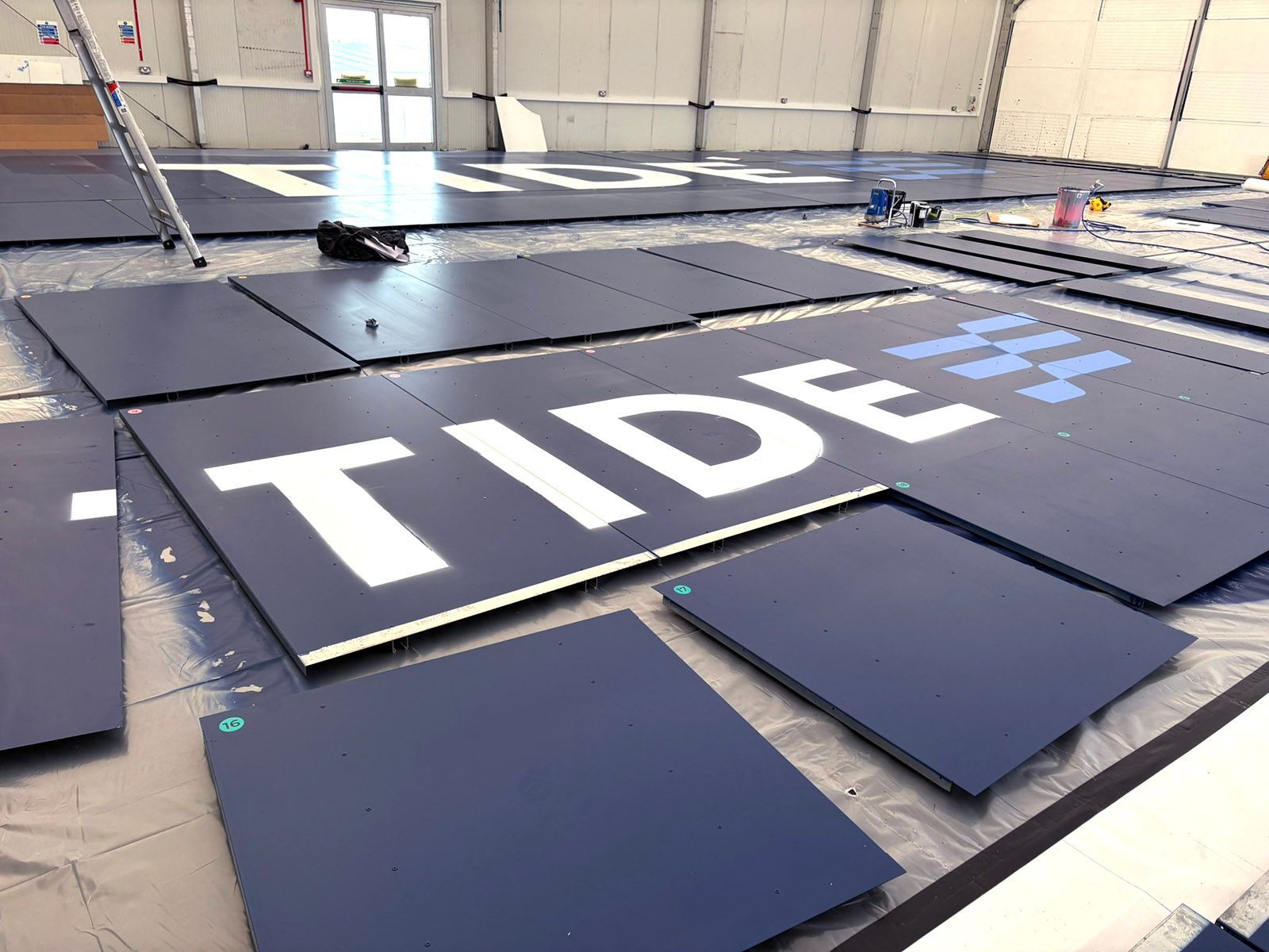 Tide logo large scale hoardings being painted