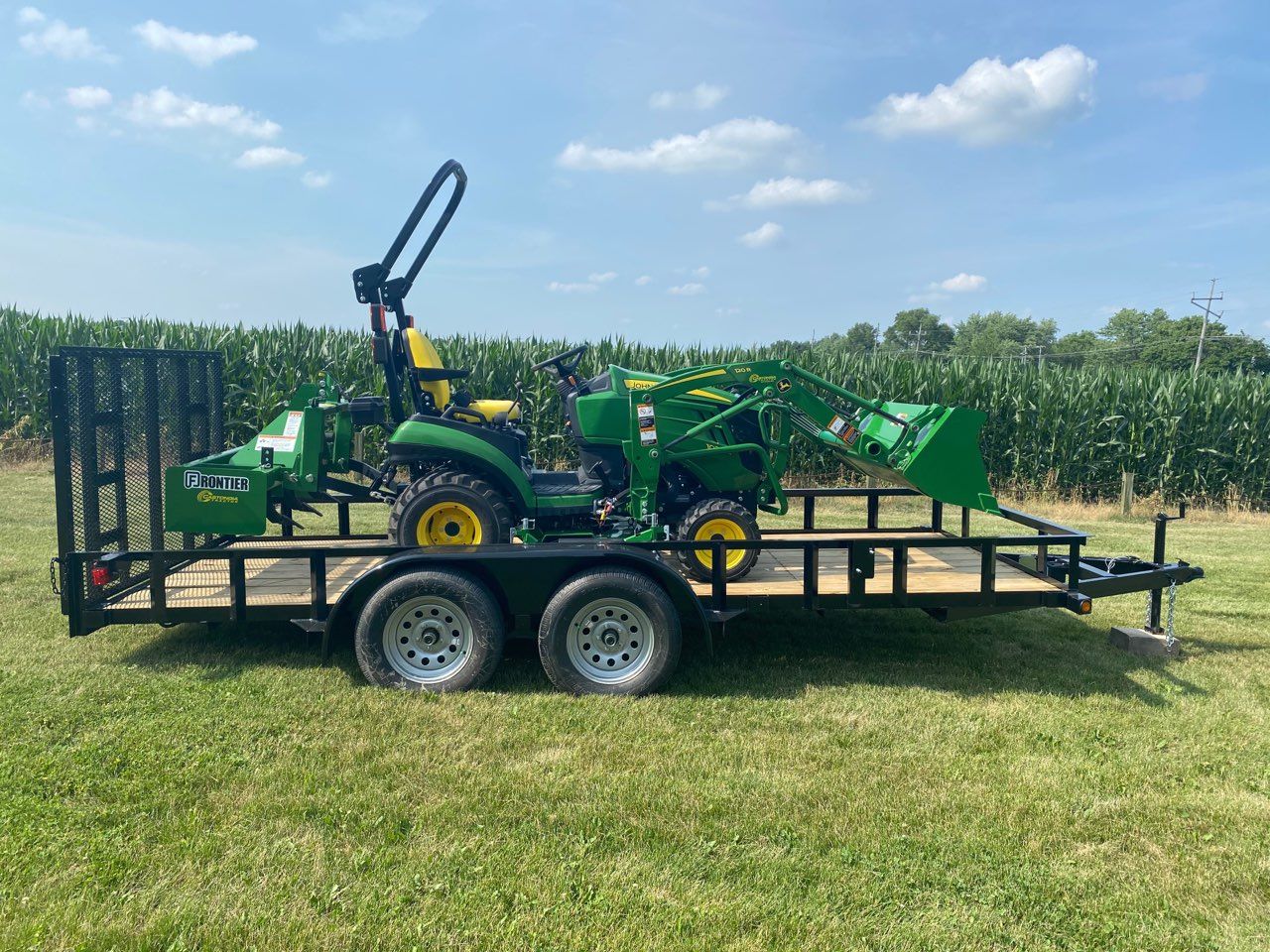 John Deere compact utility tractor on a trailer