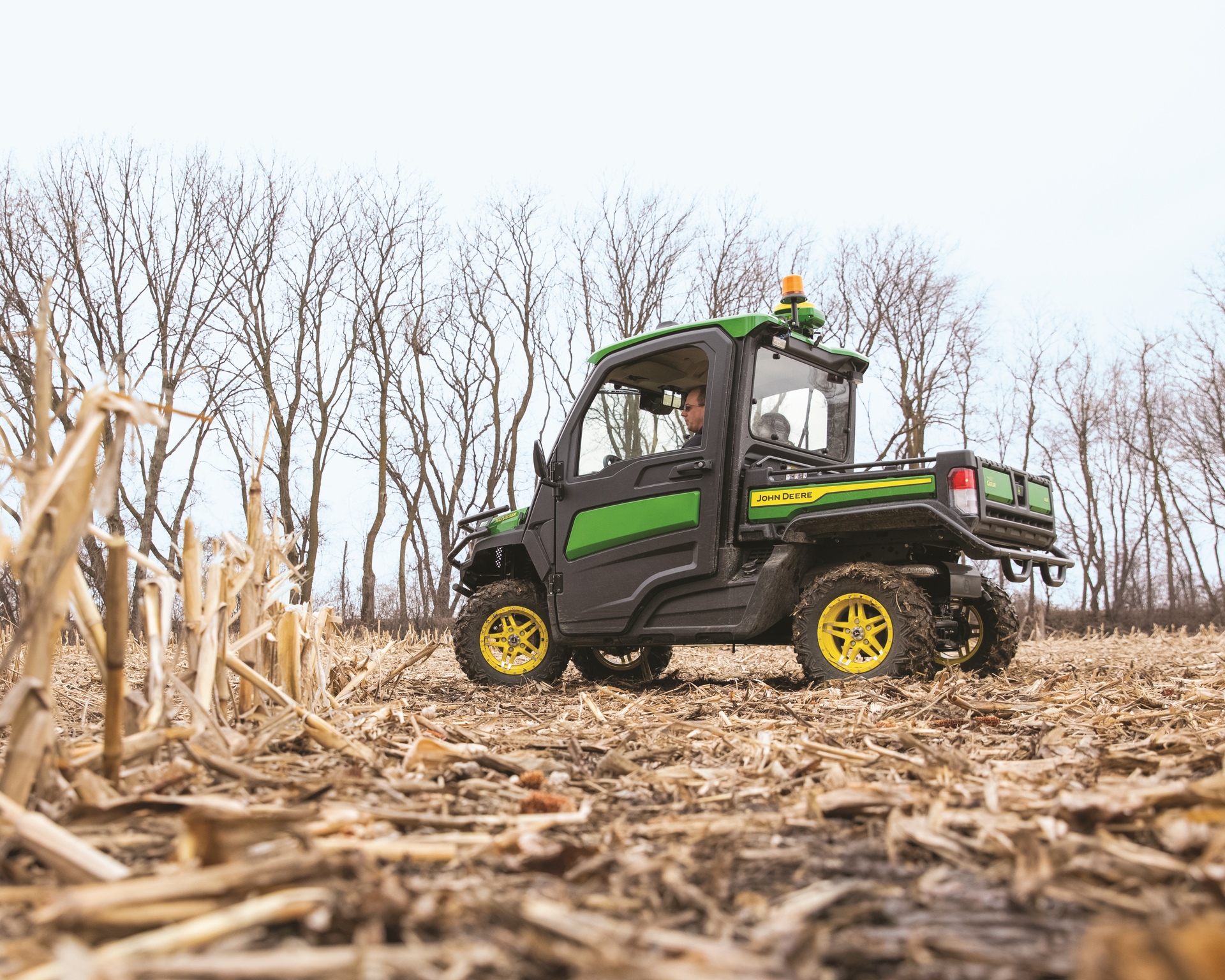 John Deere Gator in harvested corn field