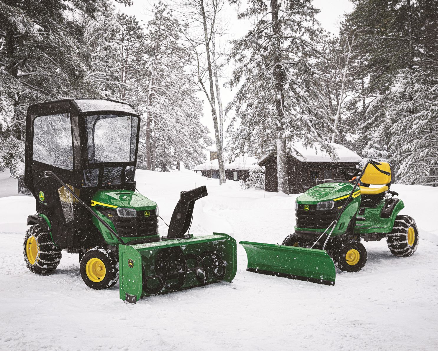 John Deere mowers converted to push snow in a blanket of white snow