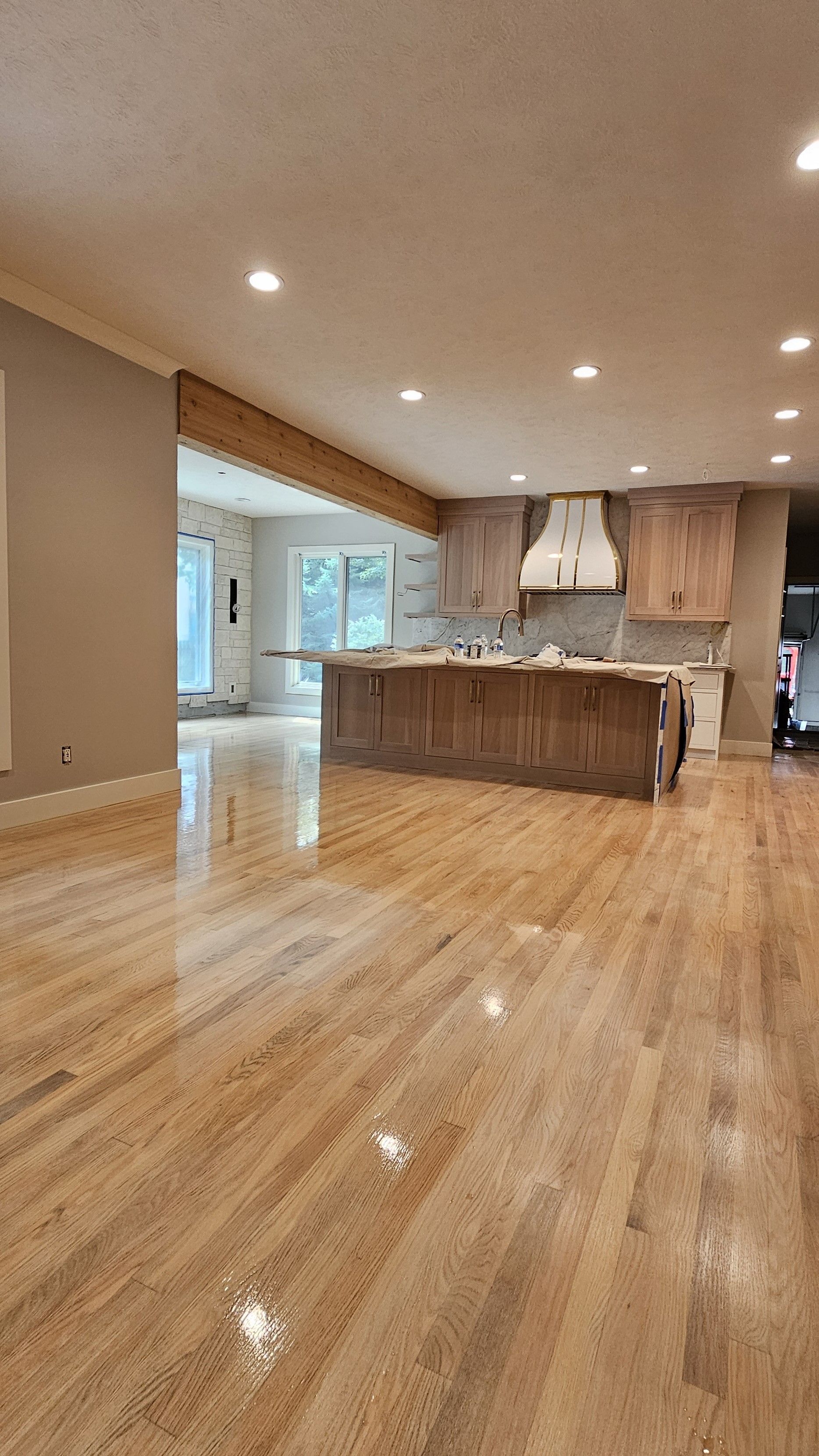 Refinished hardwood flooring in a kitchen and living room