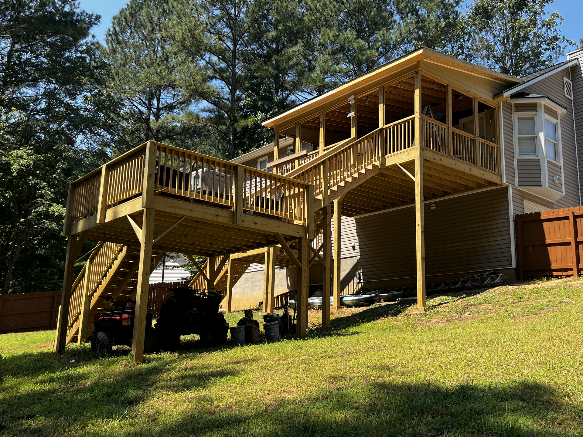 A house with a large wooden deck and stairs
