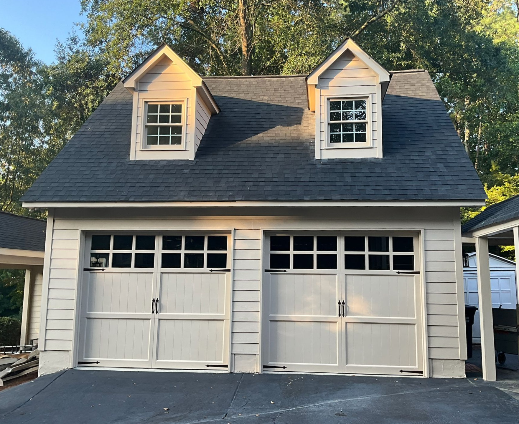 A kitchen with a wooden table and white chairs
