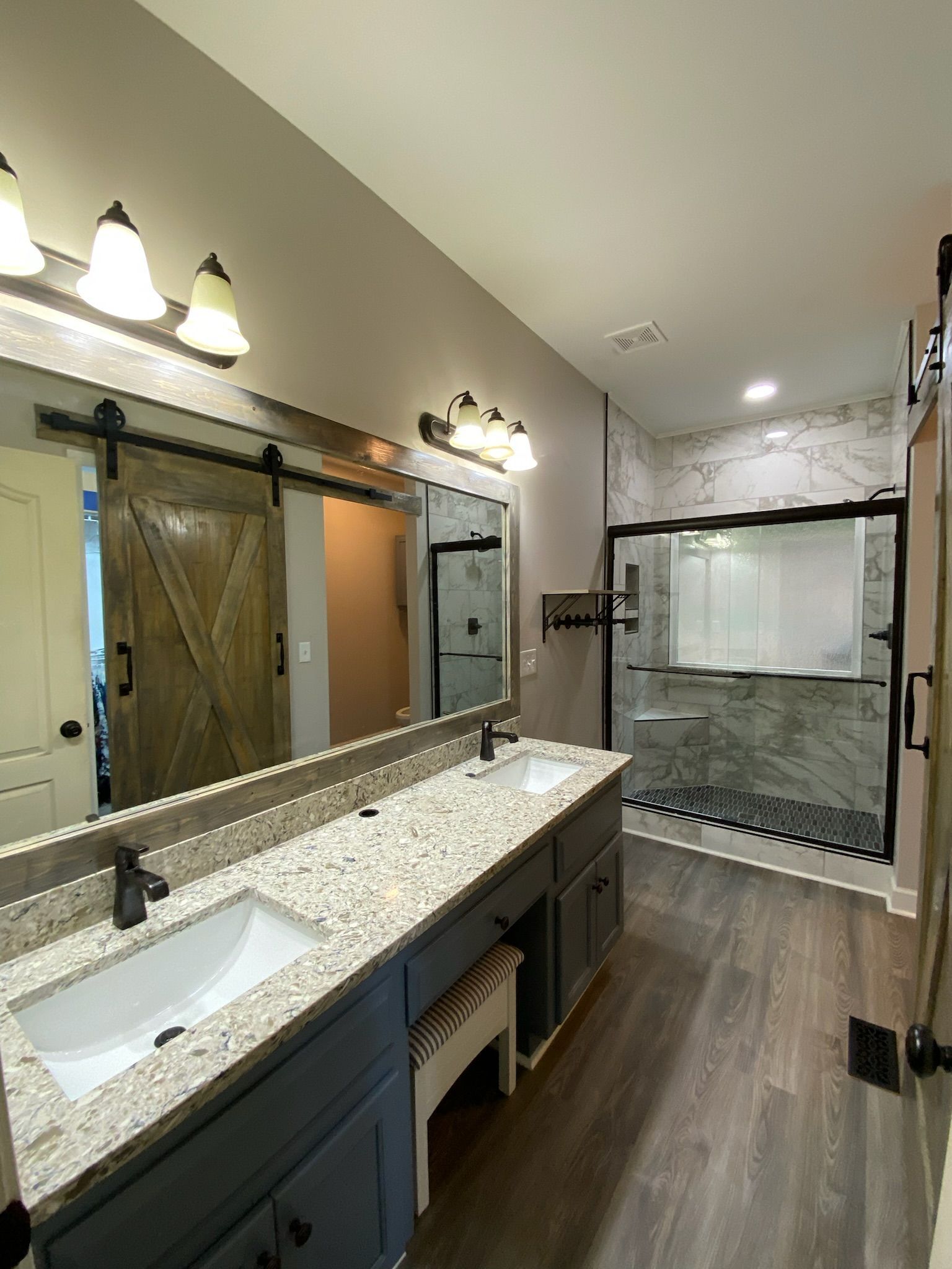 A bathroom with a shower curtain and a mirror