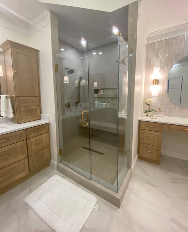 A bathroom with a walk in shower and a window