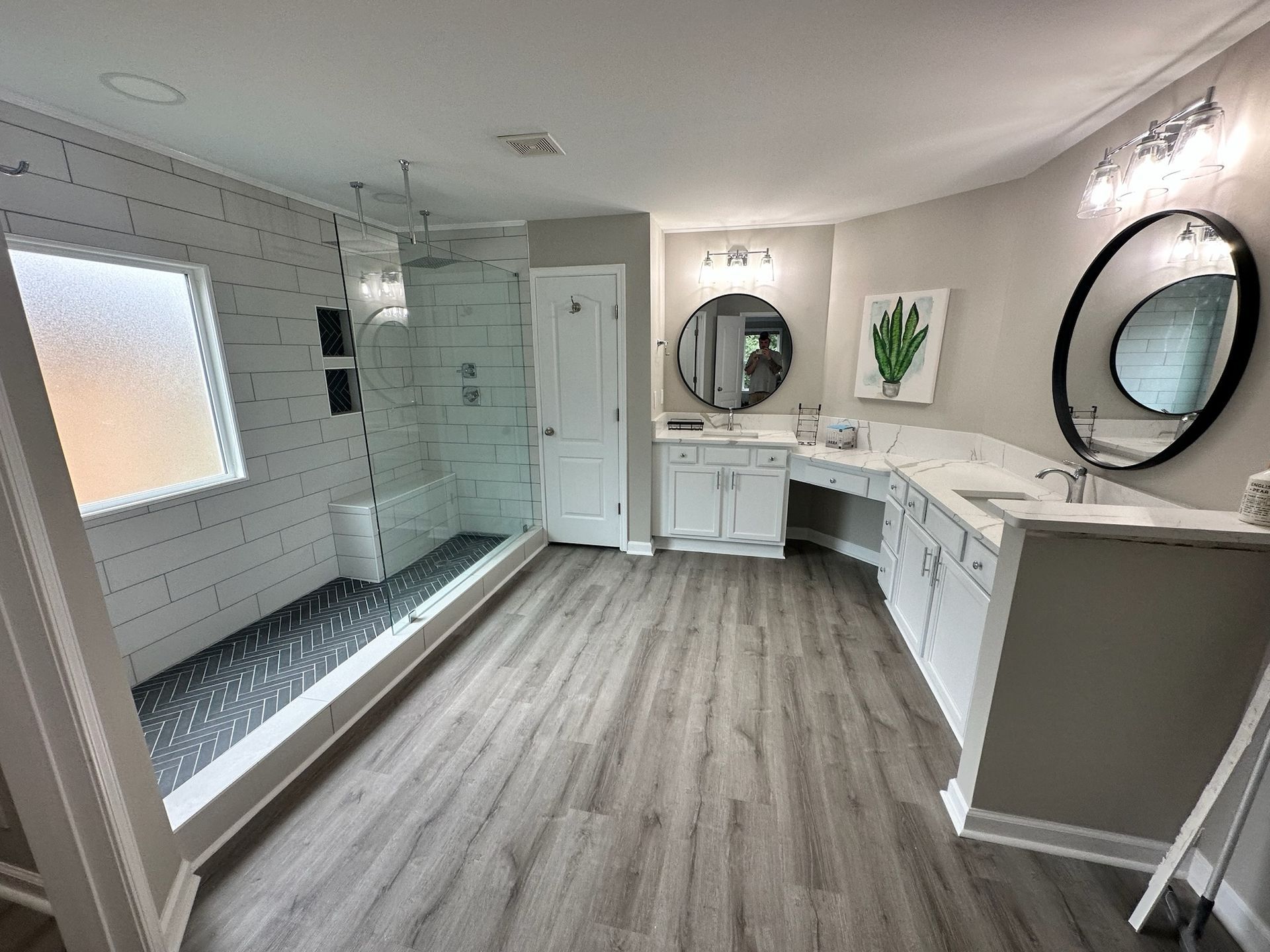 A bathroom with a tub a sink and a window