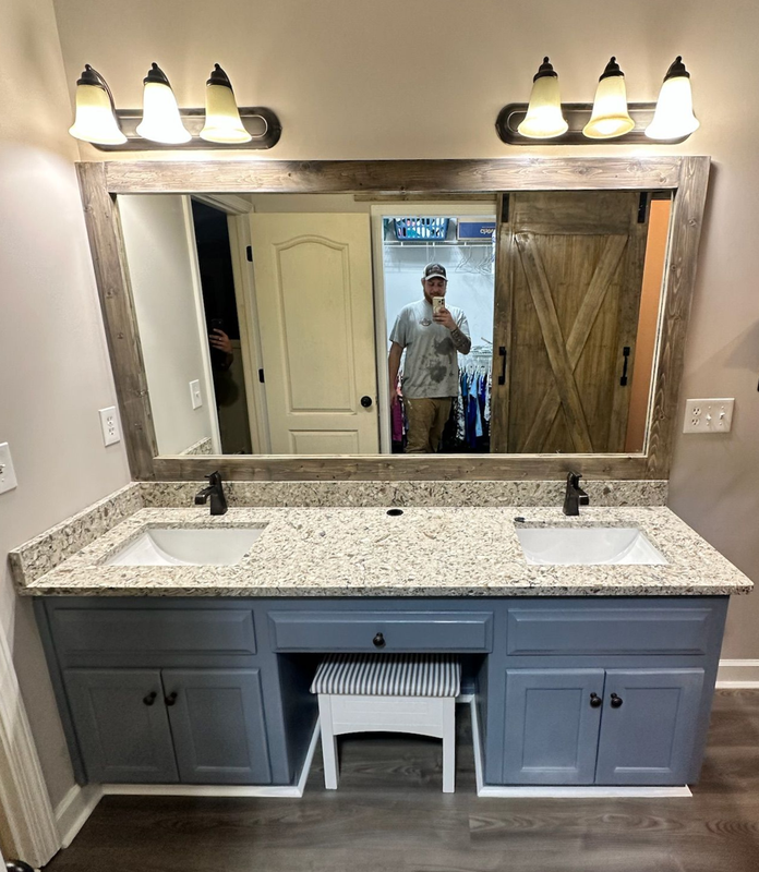 A bathroom with a toilet a sink and a walk in shower