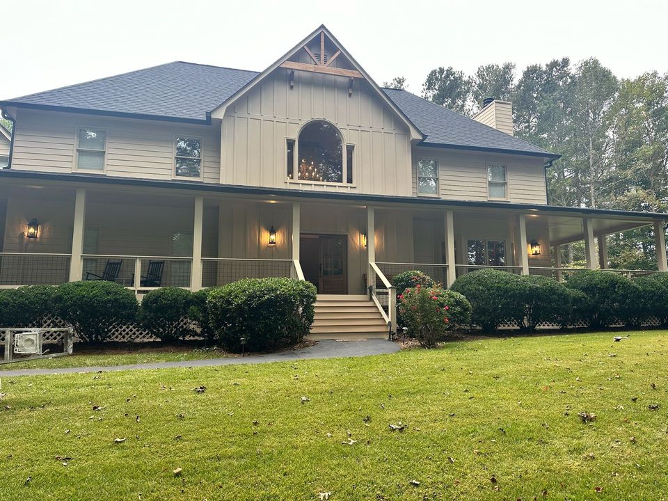 A house with a large wooden deck and stairs