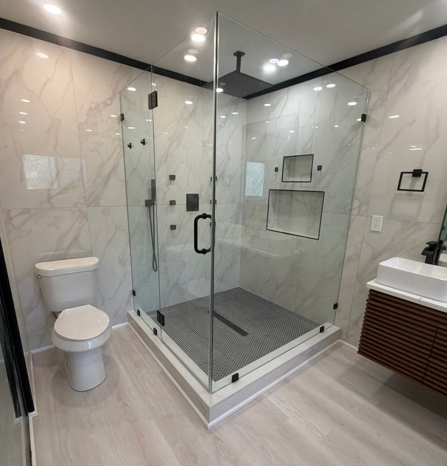 A bathroom with a bathtub a sink and a trash can
