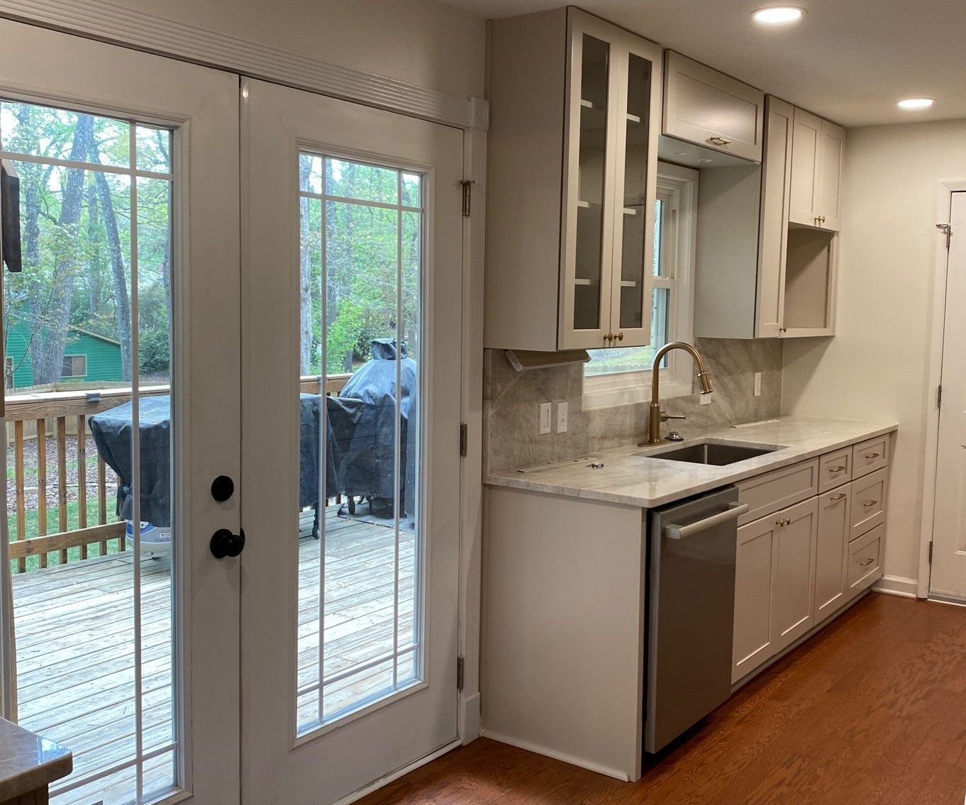 A kitchen with white cabinets and stainless steel appliances