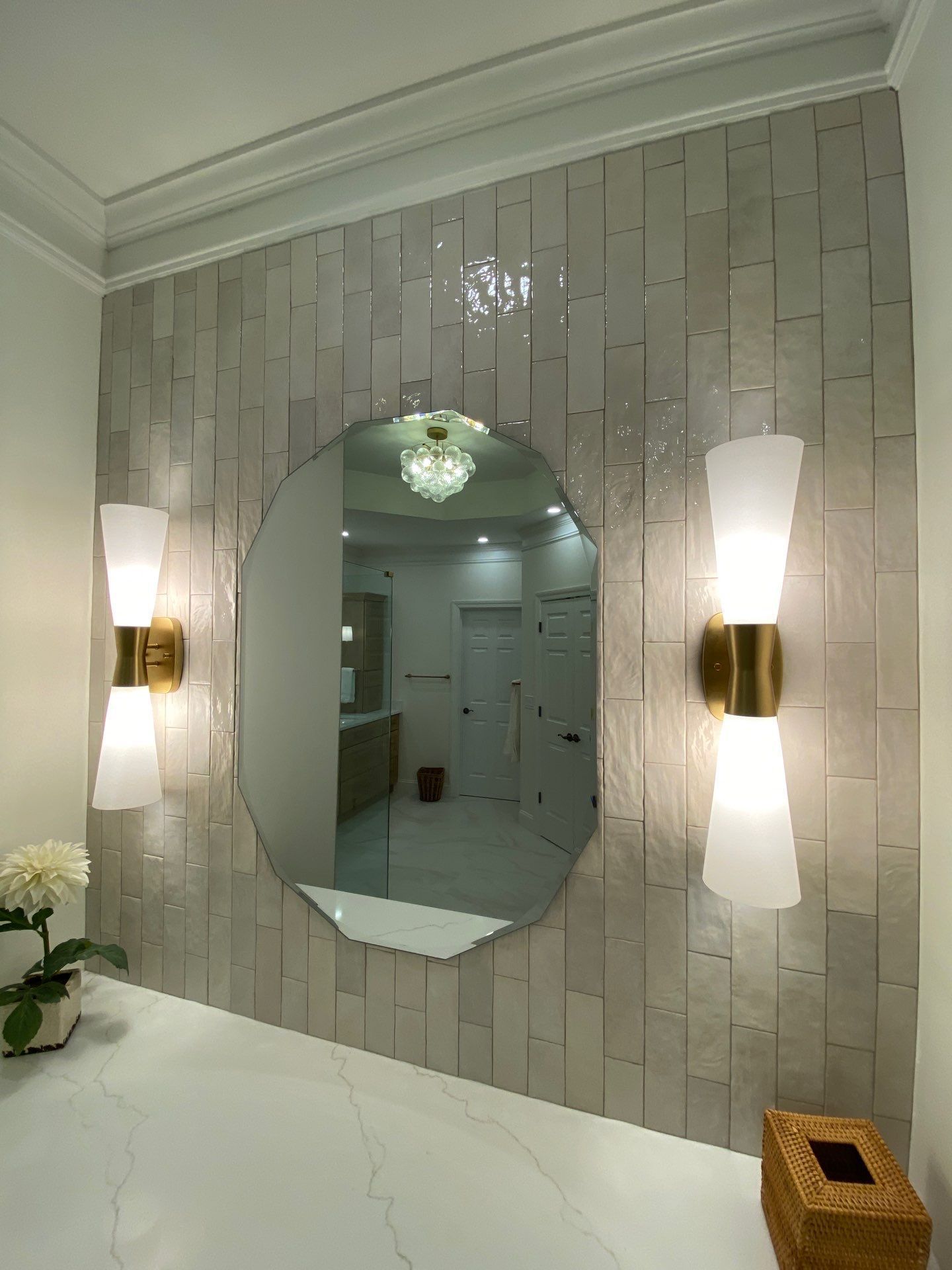 A man is installing a mirror in a bathroom.