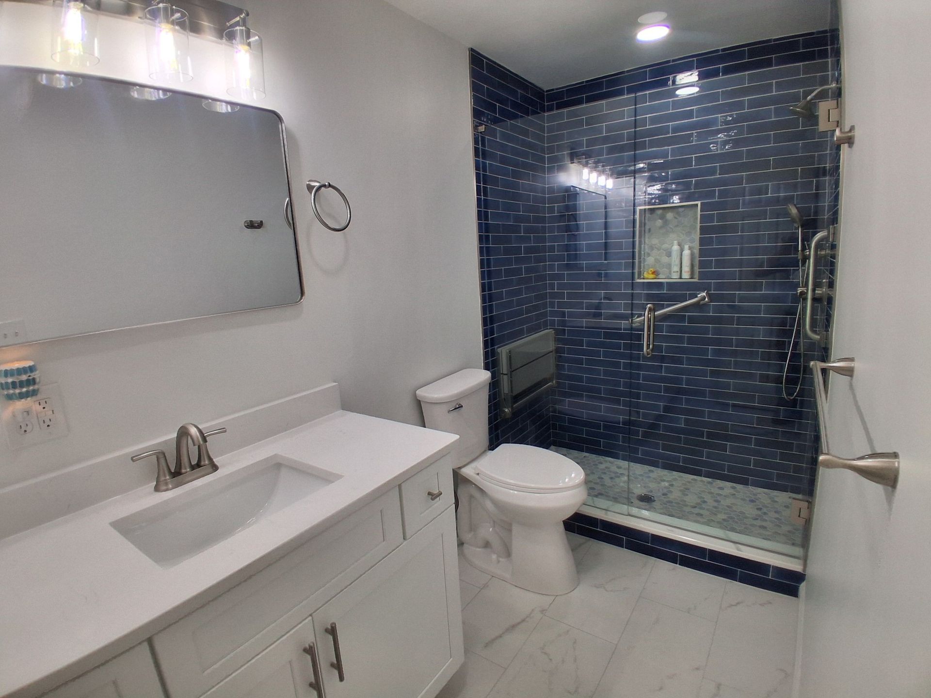 A bathroom with a tub , toilet , sink and shower.