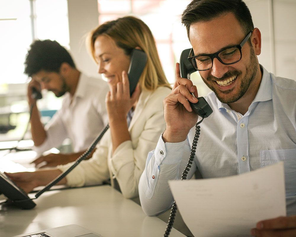 Call center representatives are on the phone with customers