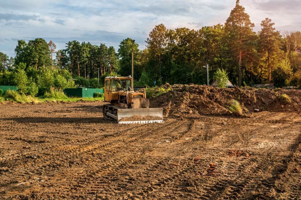 A Bulldozer Is Preparing The Site For Excavation — Urbon Sheds in Mullumbimby, NSW