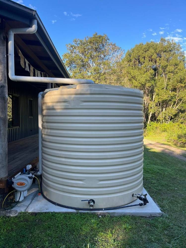 Rainwater Tank And Solar Panels On House — Urbon Sheds in Uki, NSW