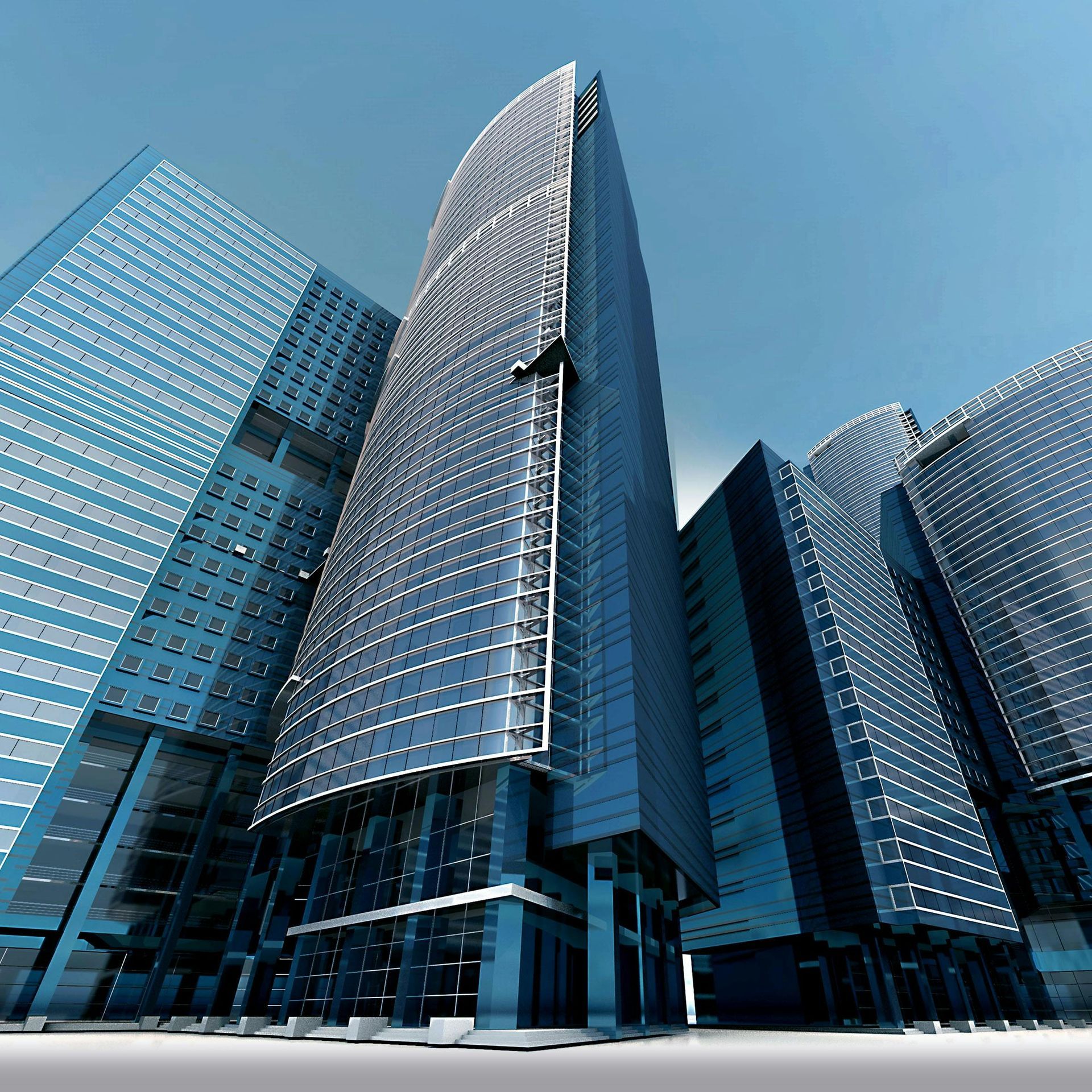 Modern glass skyscrapers against a clear blue sky.