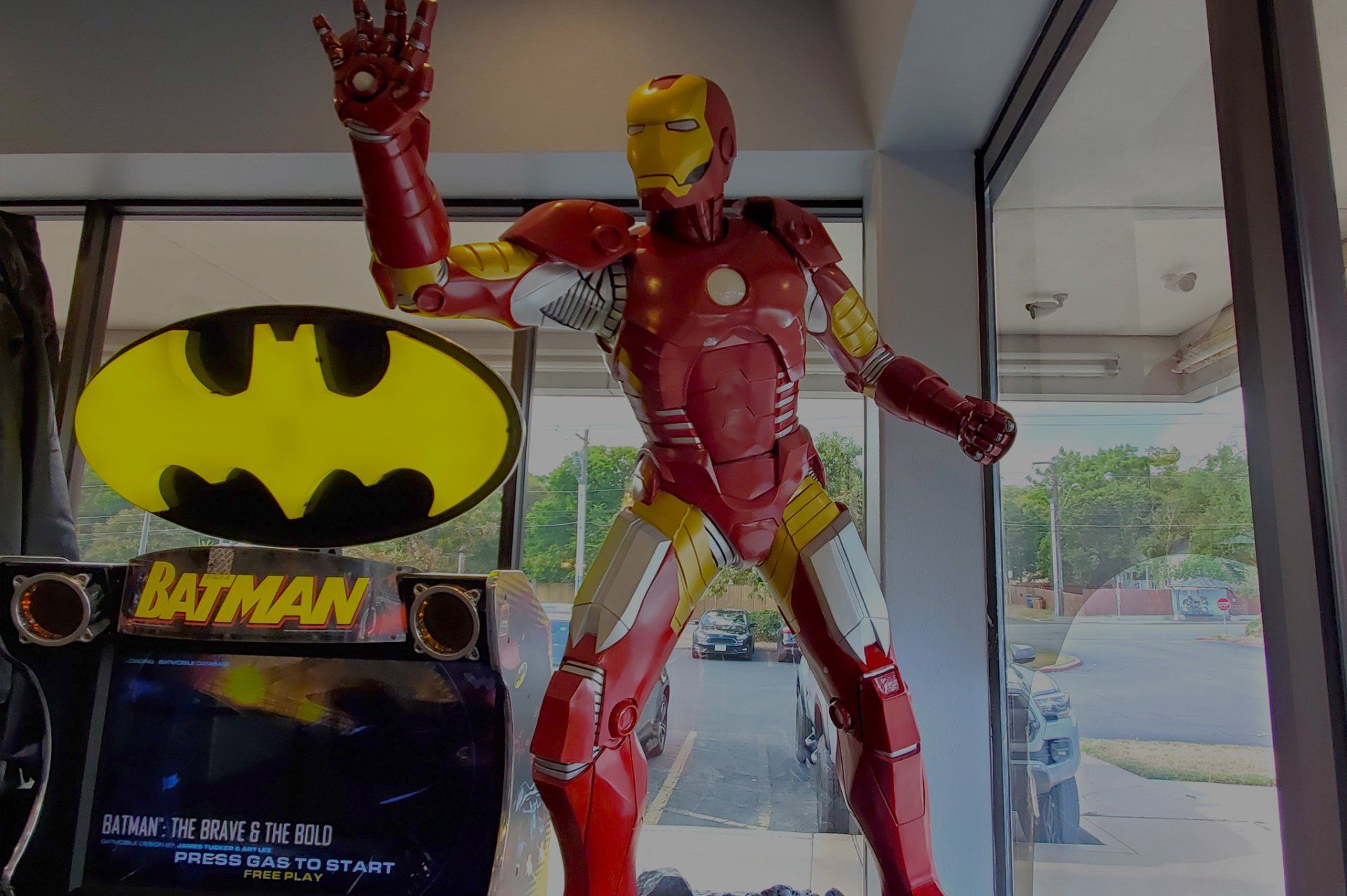 Lucent Dentistry in Austin Tx. A statue of iron man is standing in front of a batman sign.