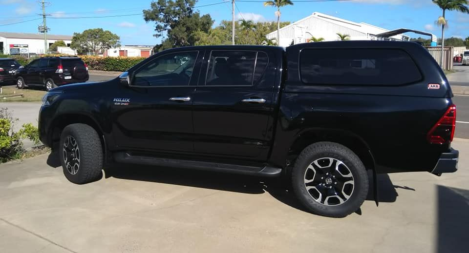 Black pickup truck parked in a driveway on a sunny day — Stay on Track 4X4 Accessories in Gladstone Central, QLD