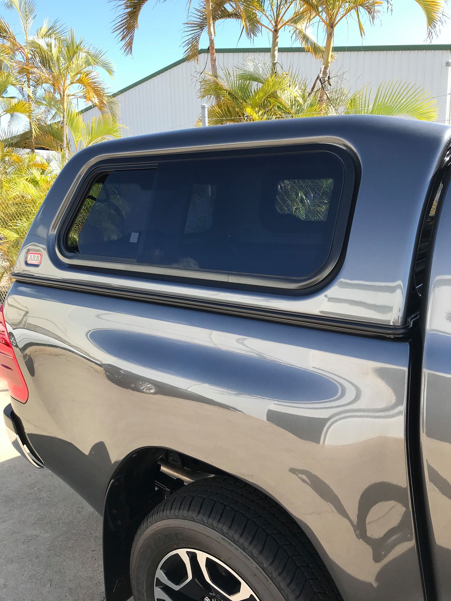 Gray pickup truck with a black camper shell parked outdoors in sunlight — Stay on Track 4X4 Accessories in Gladstone Central, QLD