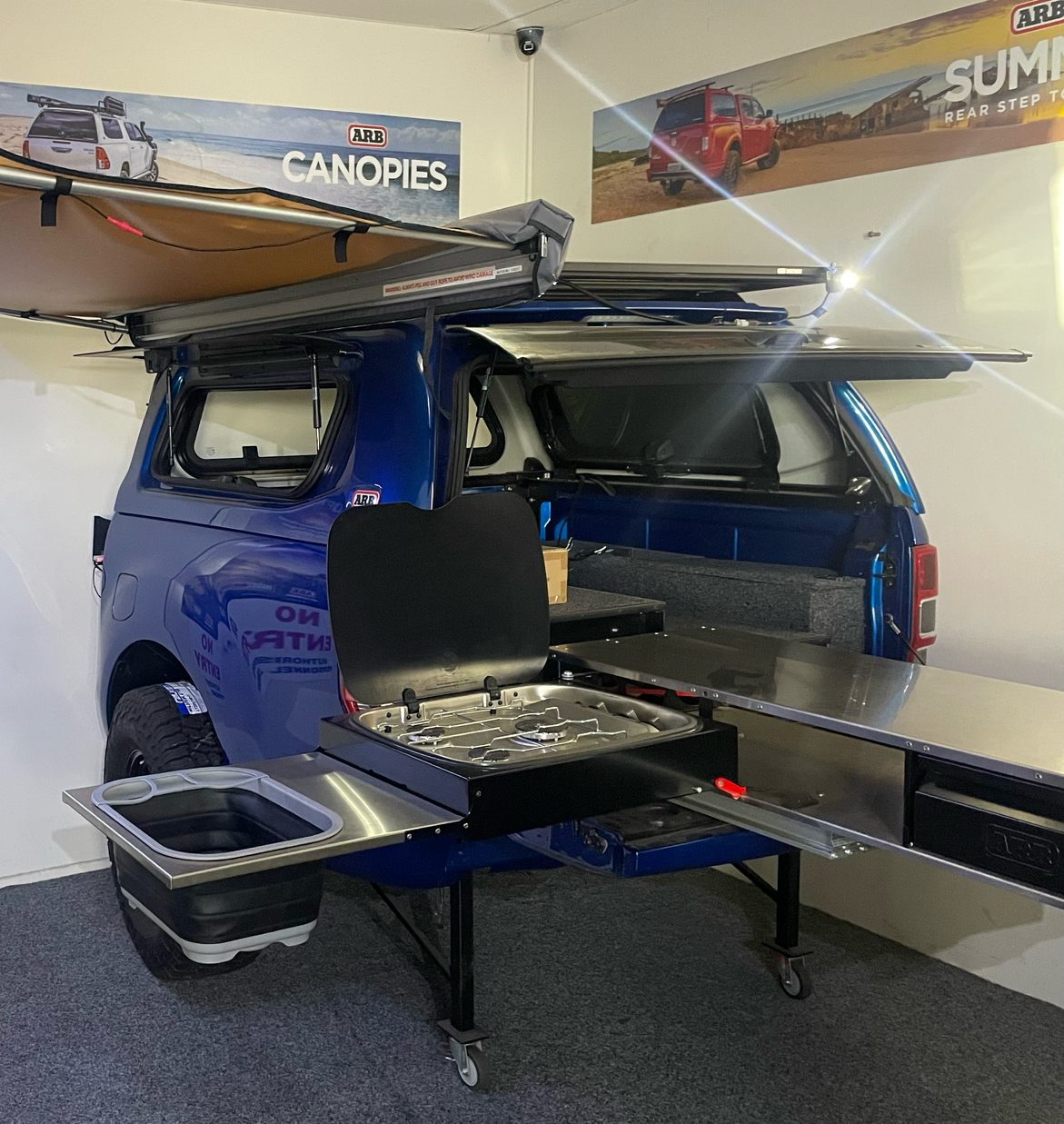 Black Pickup Truck With Camper Shell, Parked Outside on a Sunny Day — Stay on Track 4X4 Accessories in Gladstone Central, QLD