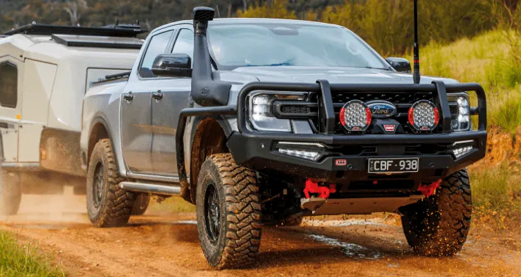 Black Jeep Wrangler tire on rocky terrain — Stay on Track 4X4 Accessories in Gladstone Central, QLD