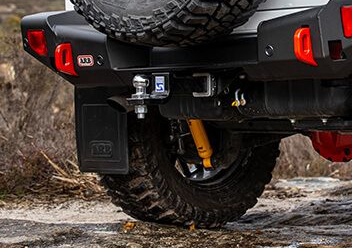 Underside of a Lifted Off-road Vehicle With Large Black Tires — Stay on Track 4X4 Accessories in Gladstone Central, QLD