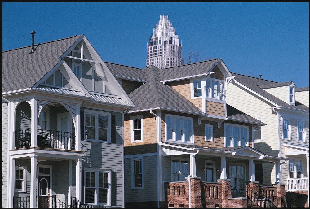 A row of houses with a large building in the background
