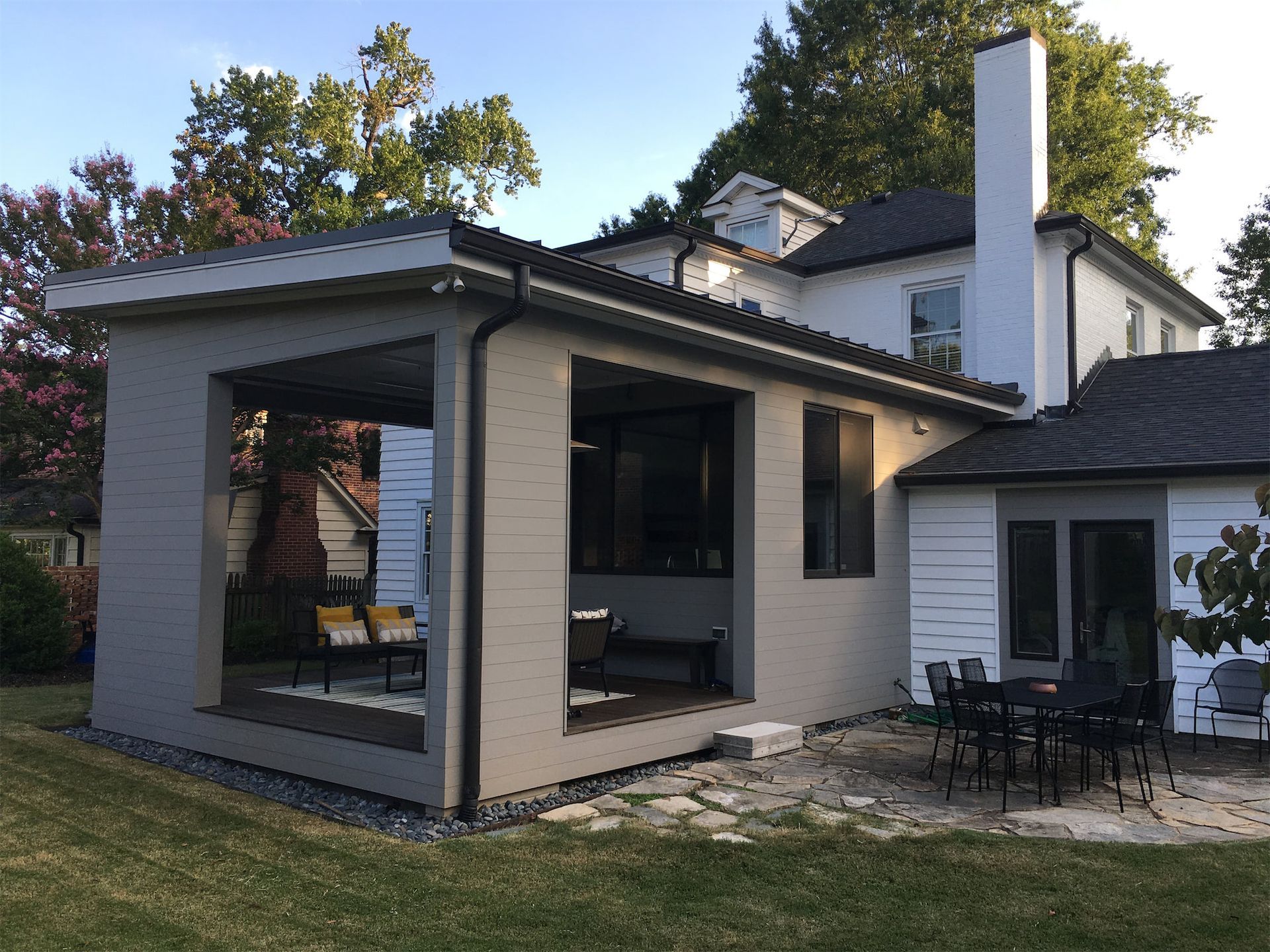 The back of a house with a large porch and patio area