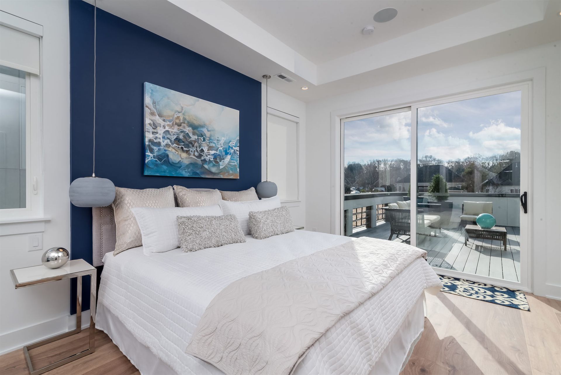 A bedroom with a large bed and a sliding glass door