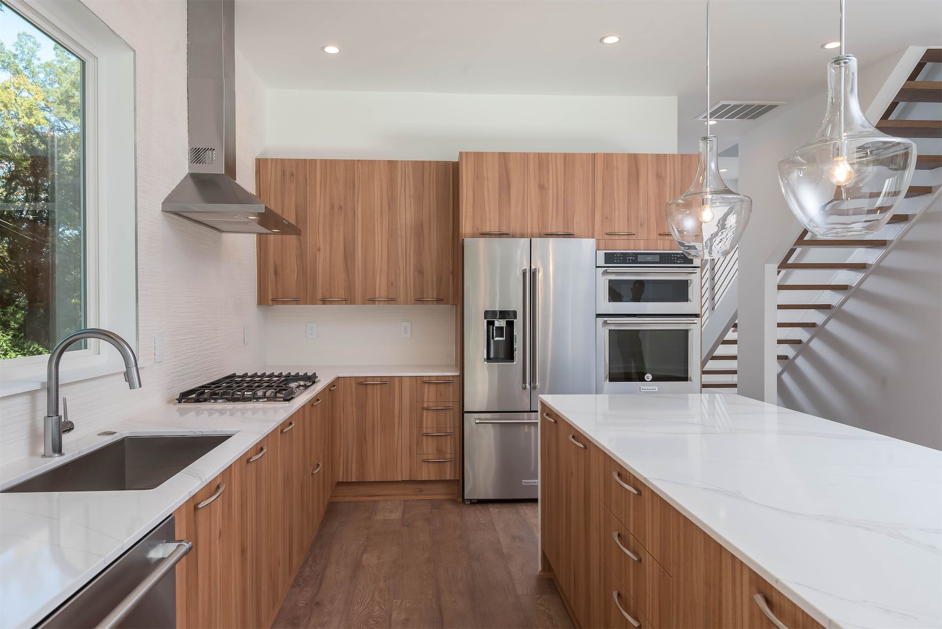 A kitchen with stainless steel appliances and wooden cabinets