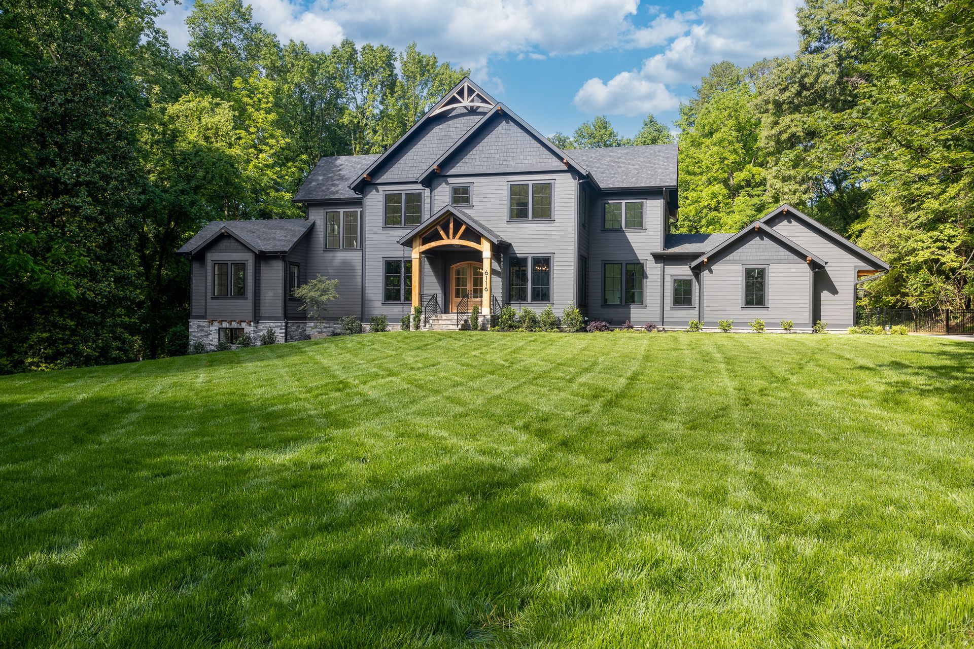 A large house with a lush green lawn in front of it.