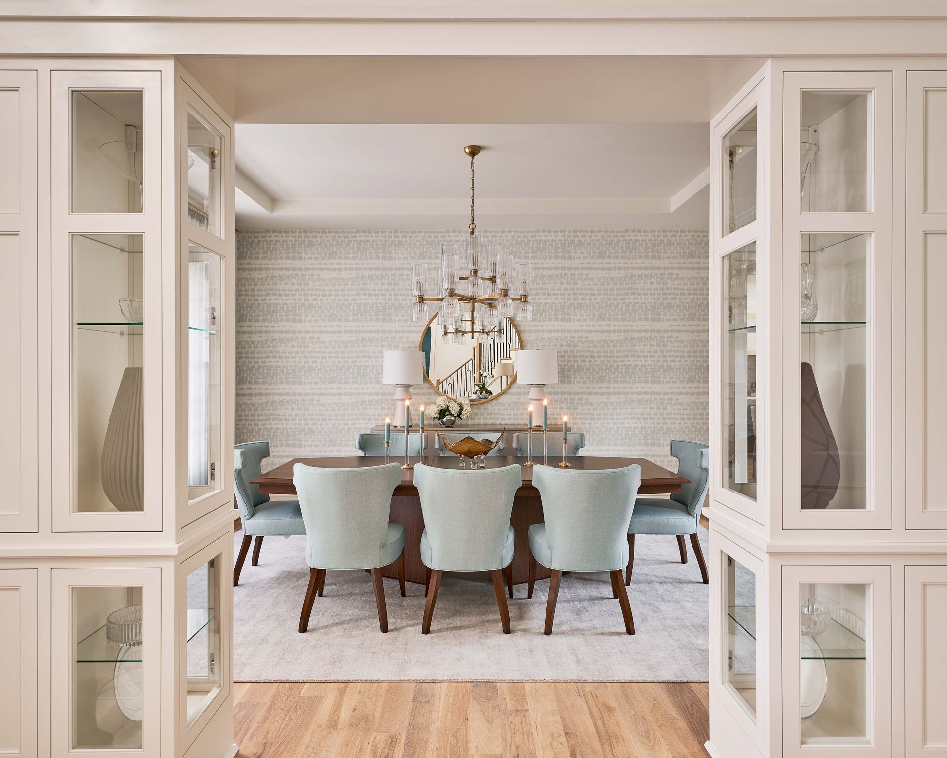 A dining room with a table and chairs and a chandelier