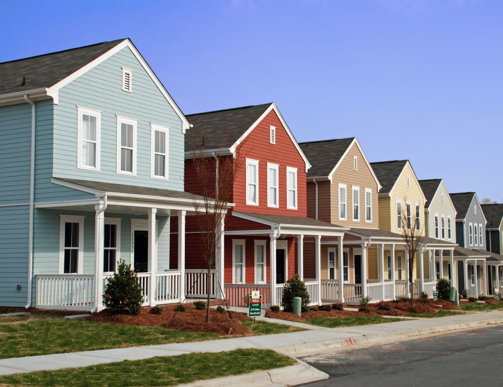 A row of houses with porches in a residential neighborhood
