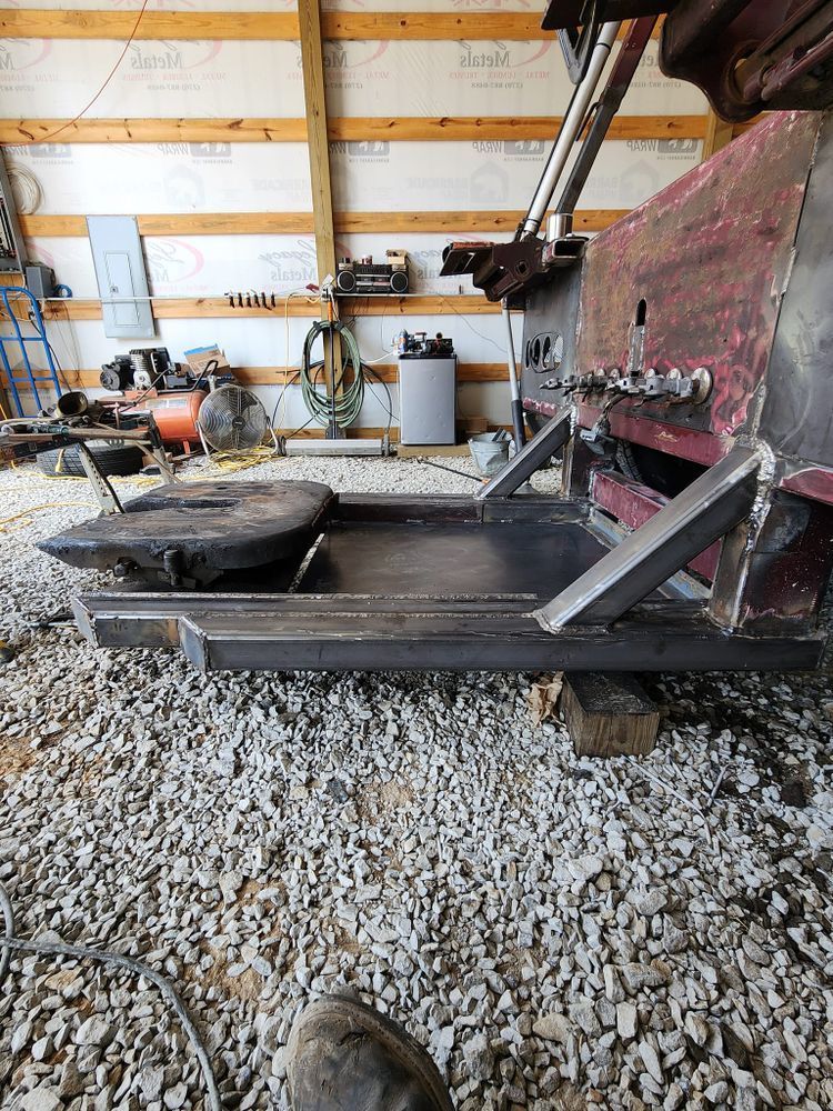 A piece of metal is sitting on top of a pile of gravel in a garage.