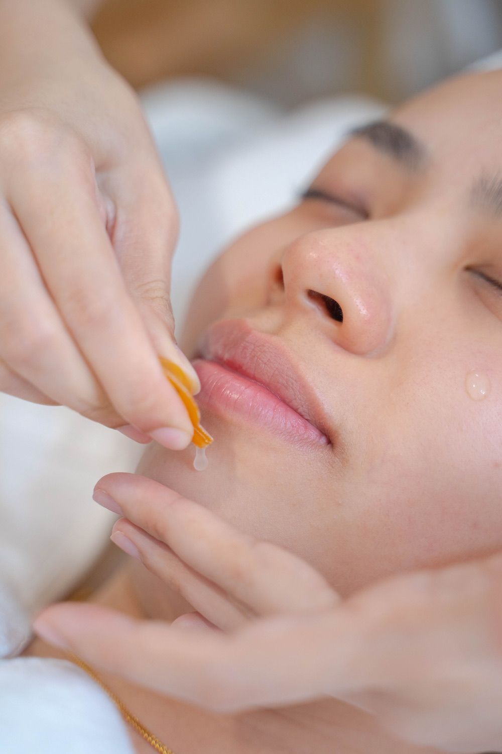 A woman is getting a facial treatment at a spa.