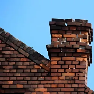 Chimney rebuilding and masonry repair service on aging brickwork