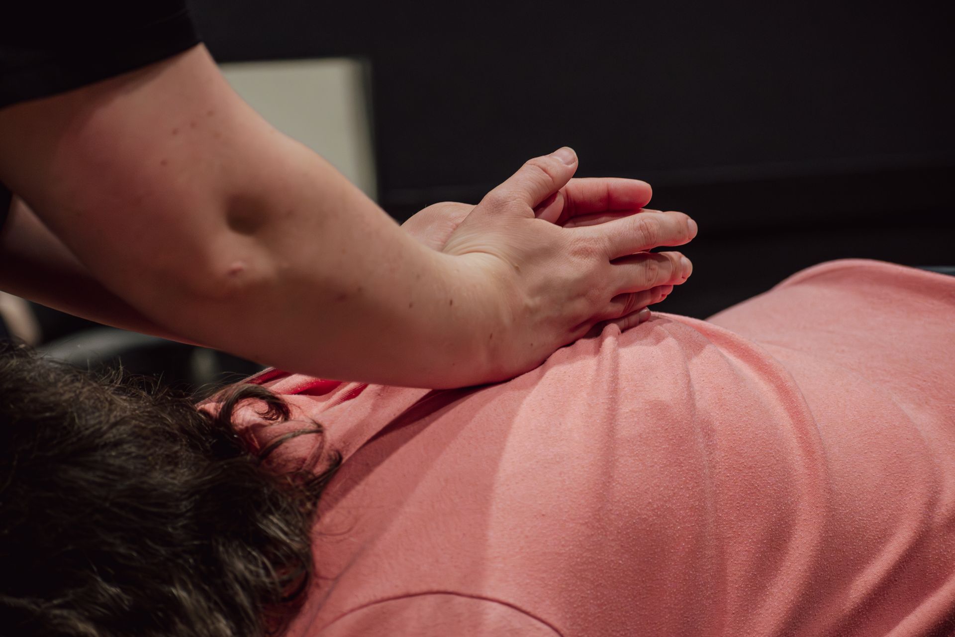 Physical therapist performing manual therapy on patient for back pain at MOSS Rehabilitation Center in Springtown Texas