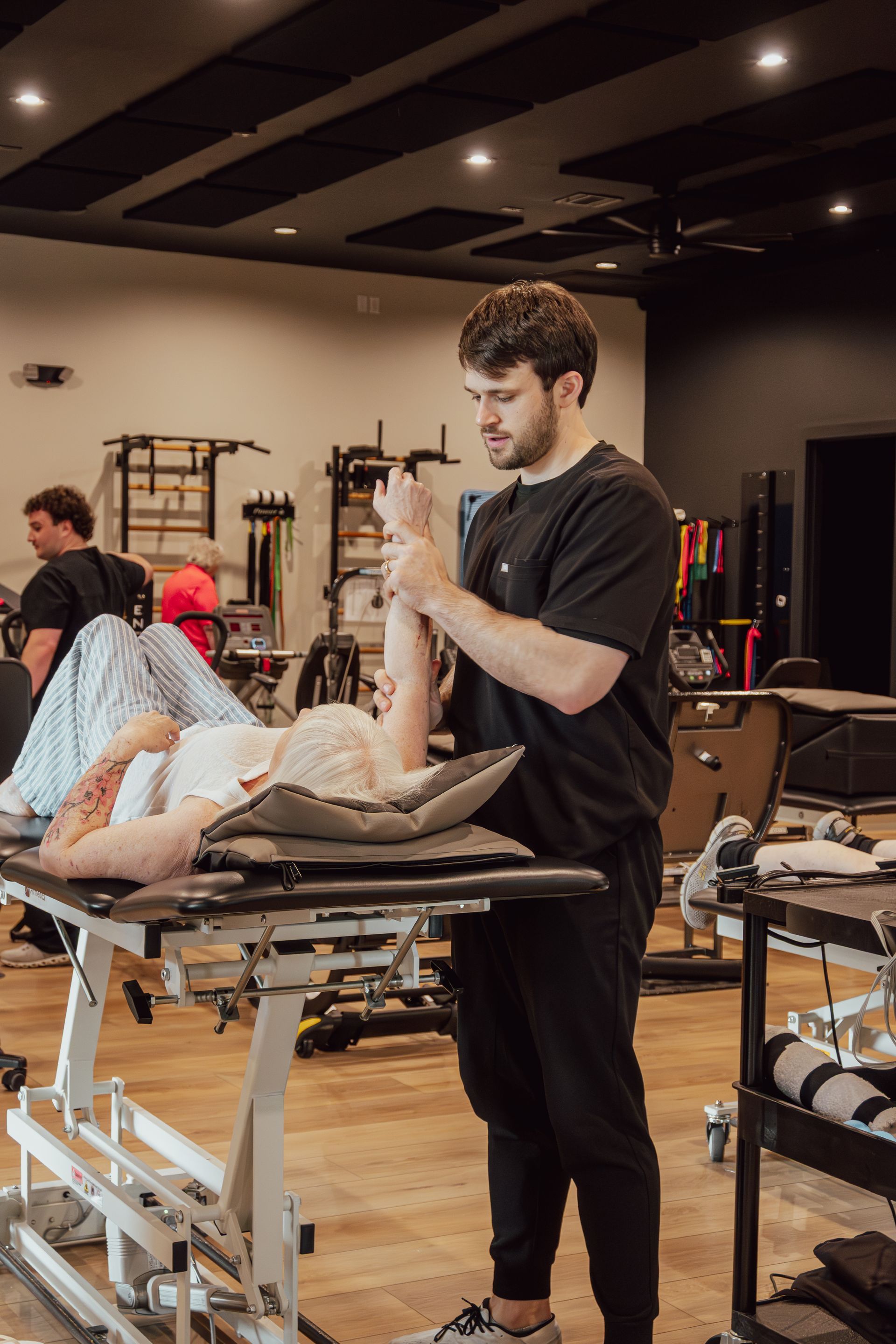 Physical therapist performing occupational therapy on patient for torn rotator cuff at MOSS Rehabilitation Center in Springtown Texas