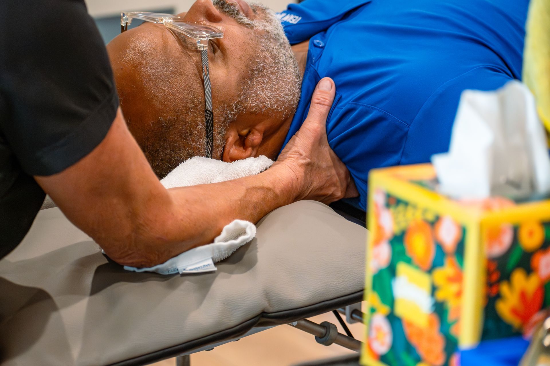 Physical therapist performing manual therapy on patient for neck pain at MOSS Rehabilitation Center in Springtown Texas