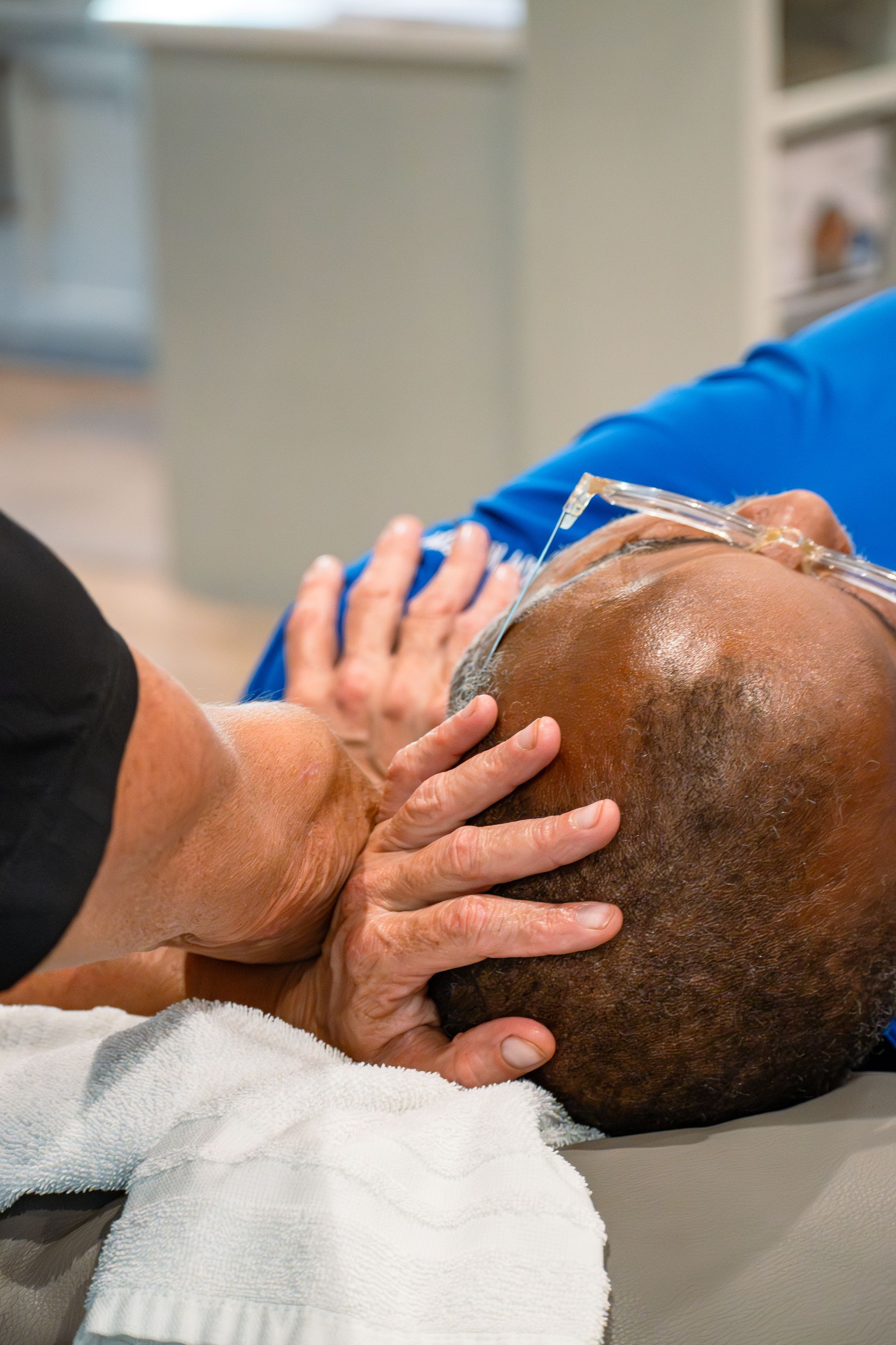 Physical therapist performing manual therapy on patient for neck pain at MOSS Rehabilitation Center in Springtown Texas