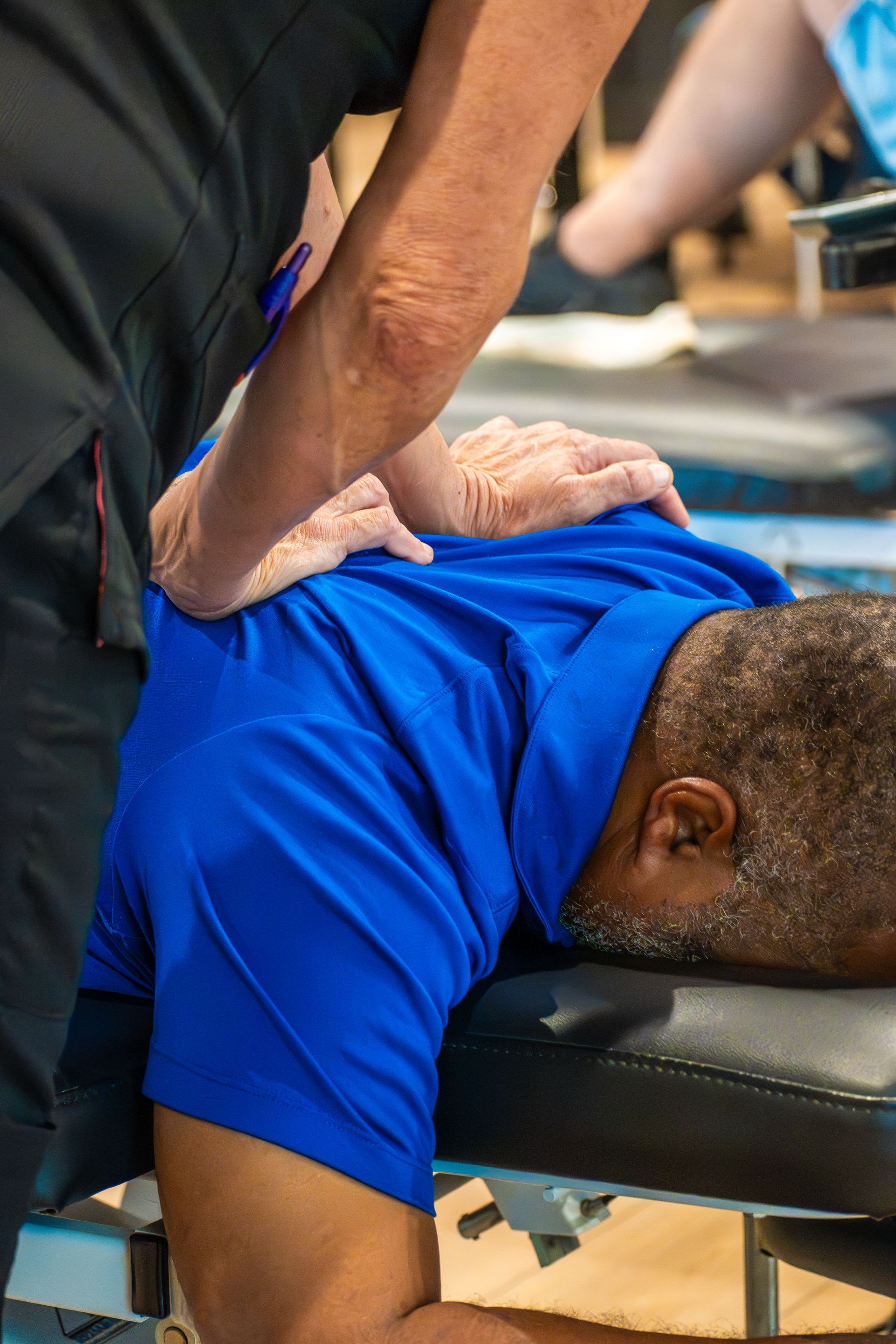 Physical therapist performing manual therapy on patient for neck pain at MOSS Rehabilitation Center in Springtown Texas