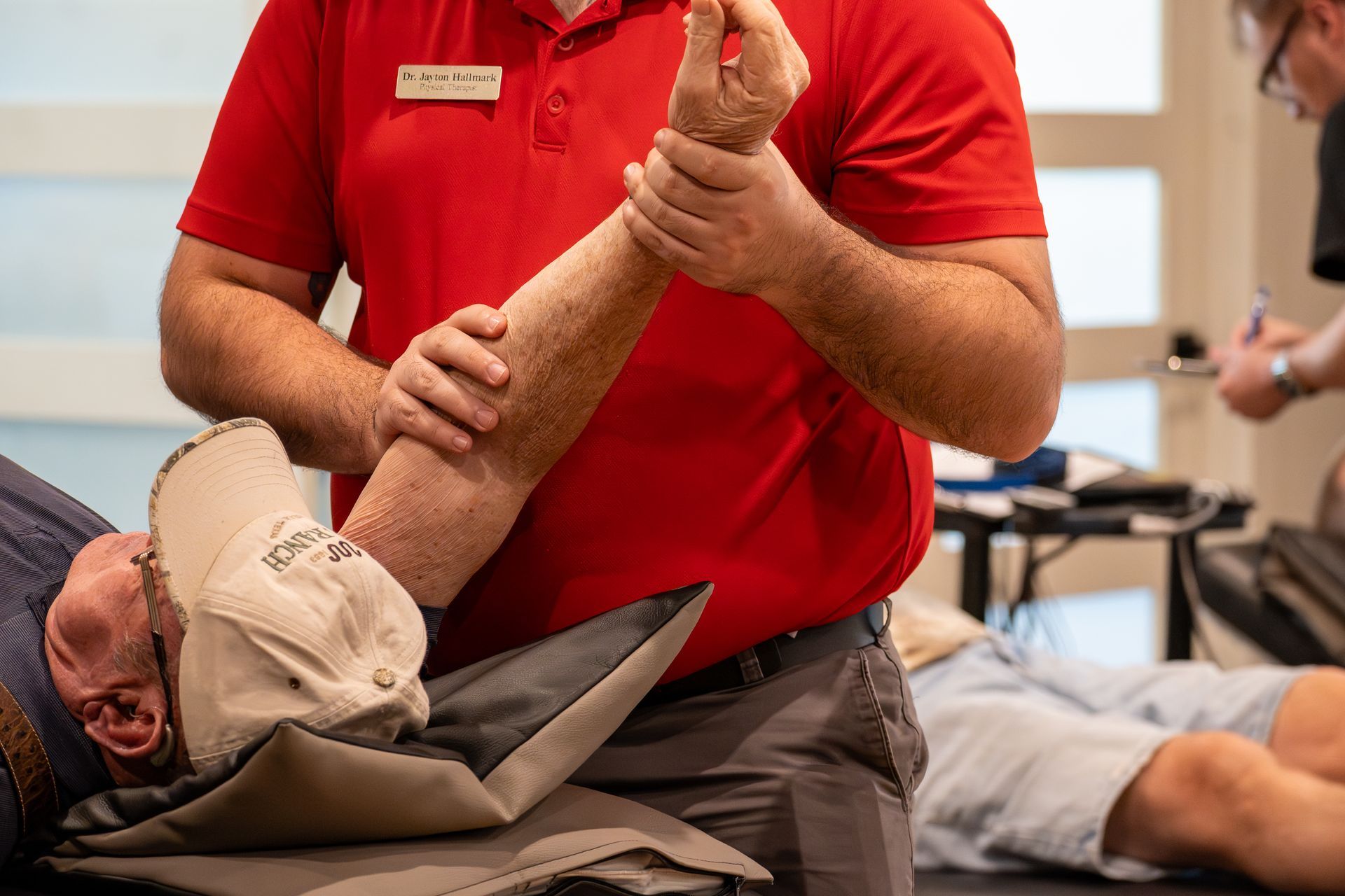 Physical therapist performing occupational therapy on patient for torn rotator cuff at MOSS Rehabilitation Center in Springtown Texas