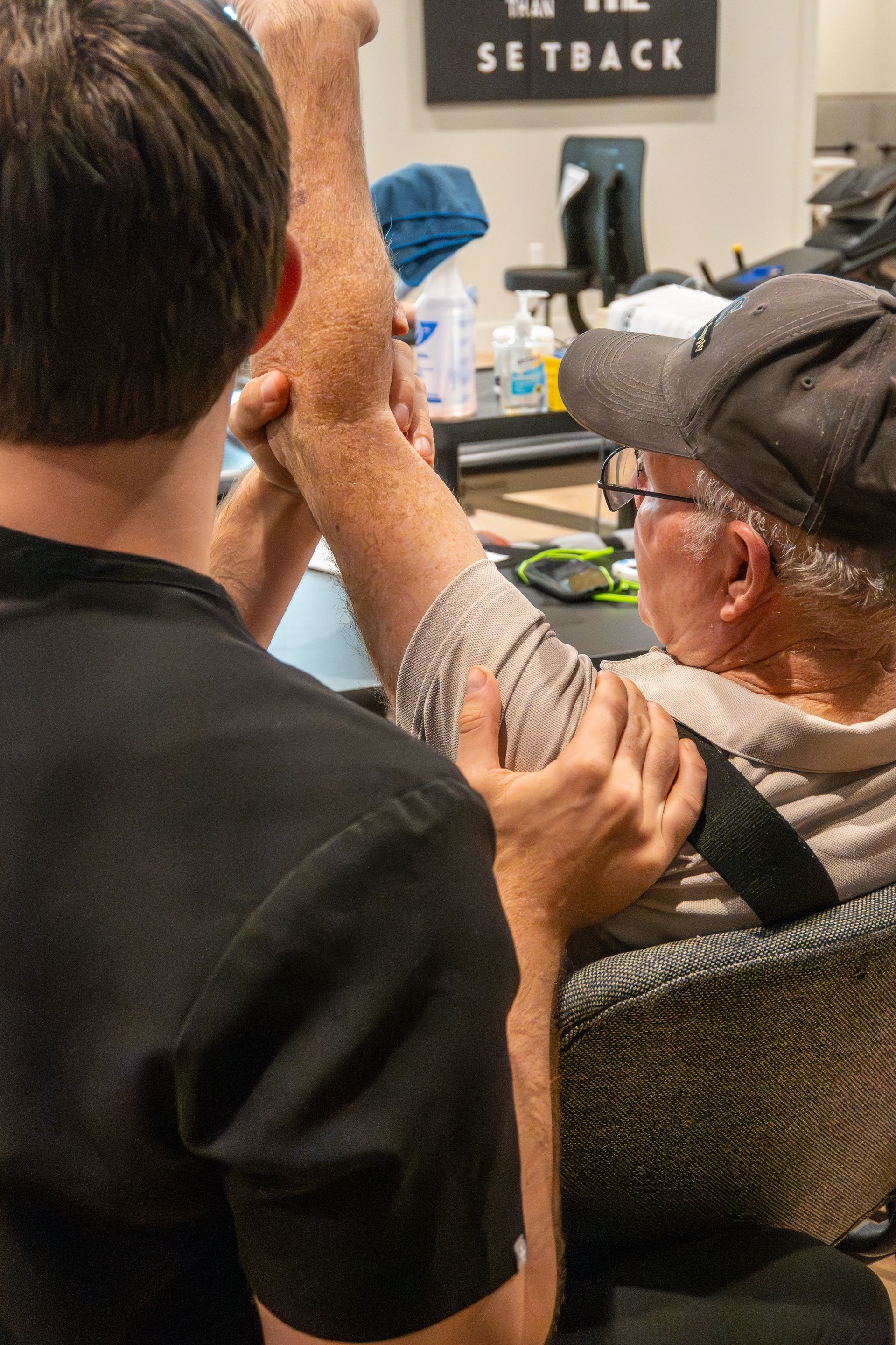 Physical therapist performing occupational therapy on patient for torn rotator cuff at MOSS Rehabilitation Center in Springtown Texas