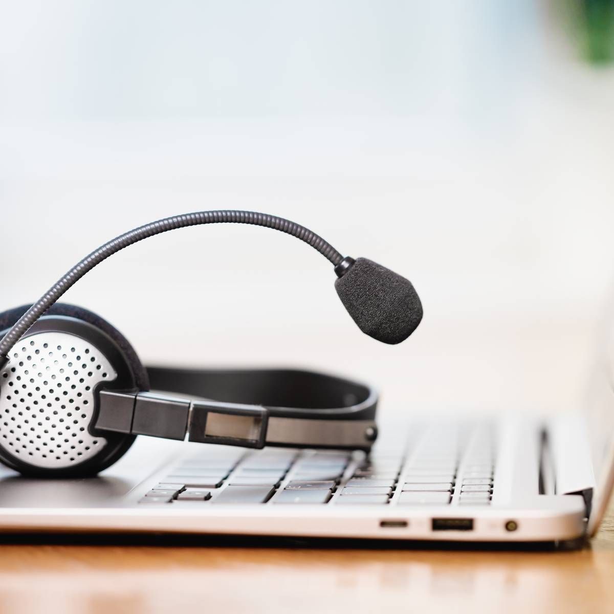 Headset with microphone on a laptop keyboard.