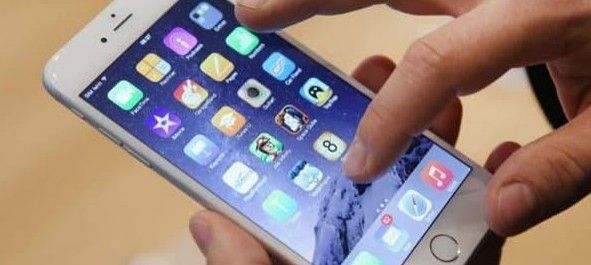 A person is holding a cell phone in their hands.