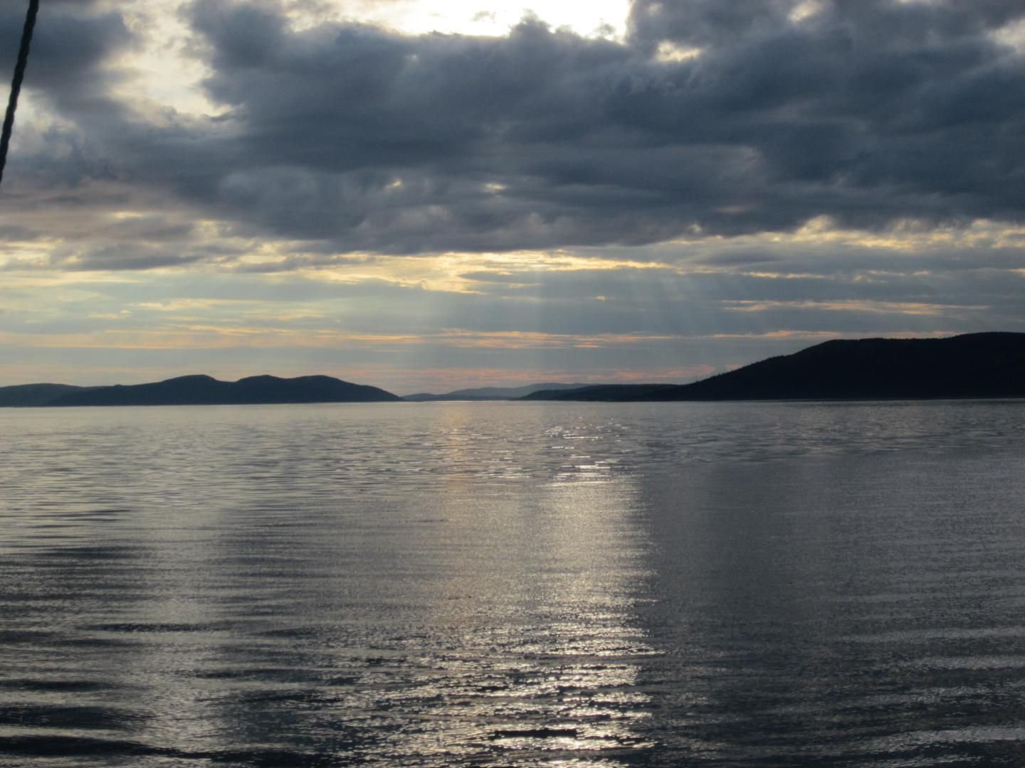 A large body of water with mountains in the background