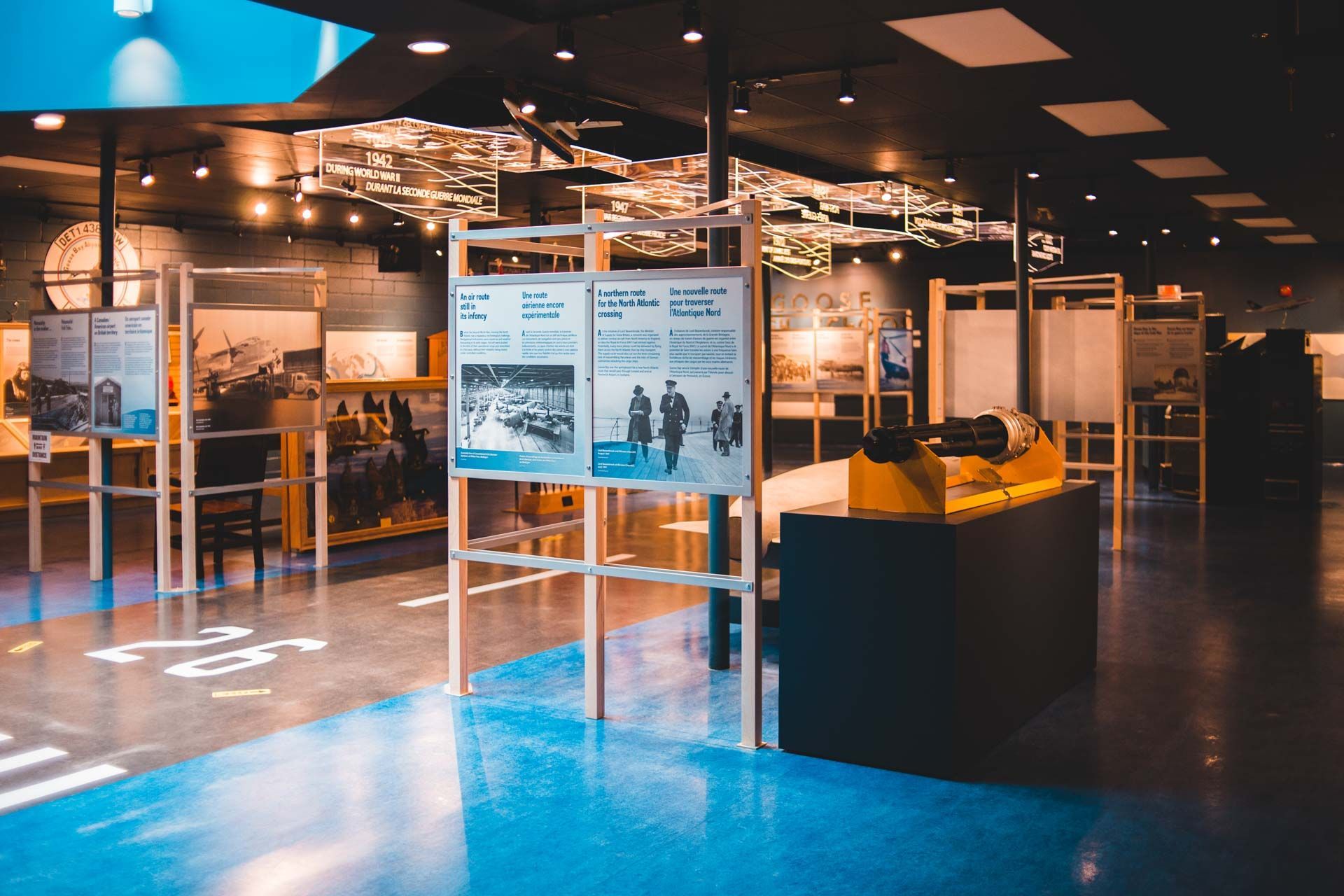 A museum with a lot of pictures on display and a blue floor.