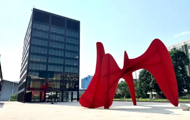 Calder Plaza sculpture in front of a tall, dark glass building grand rapids michigan.