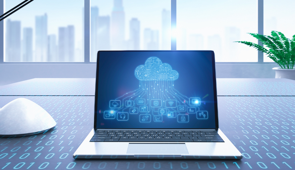 Laptop displaying a cloud computing graphic, on a desk with binary code. A white mouse and window view are visible.