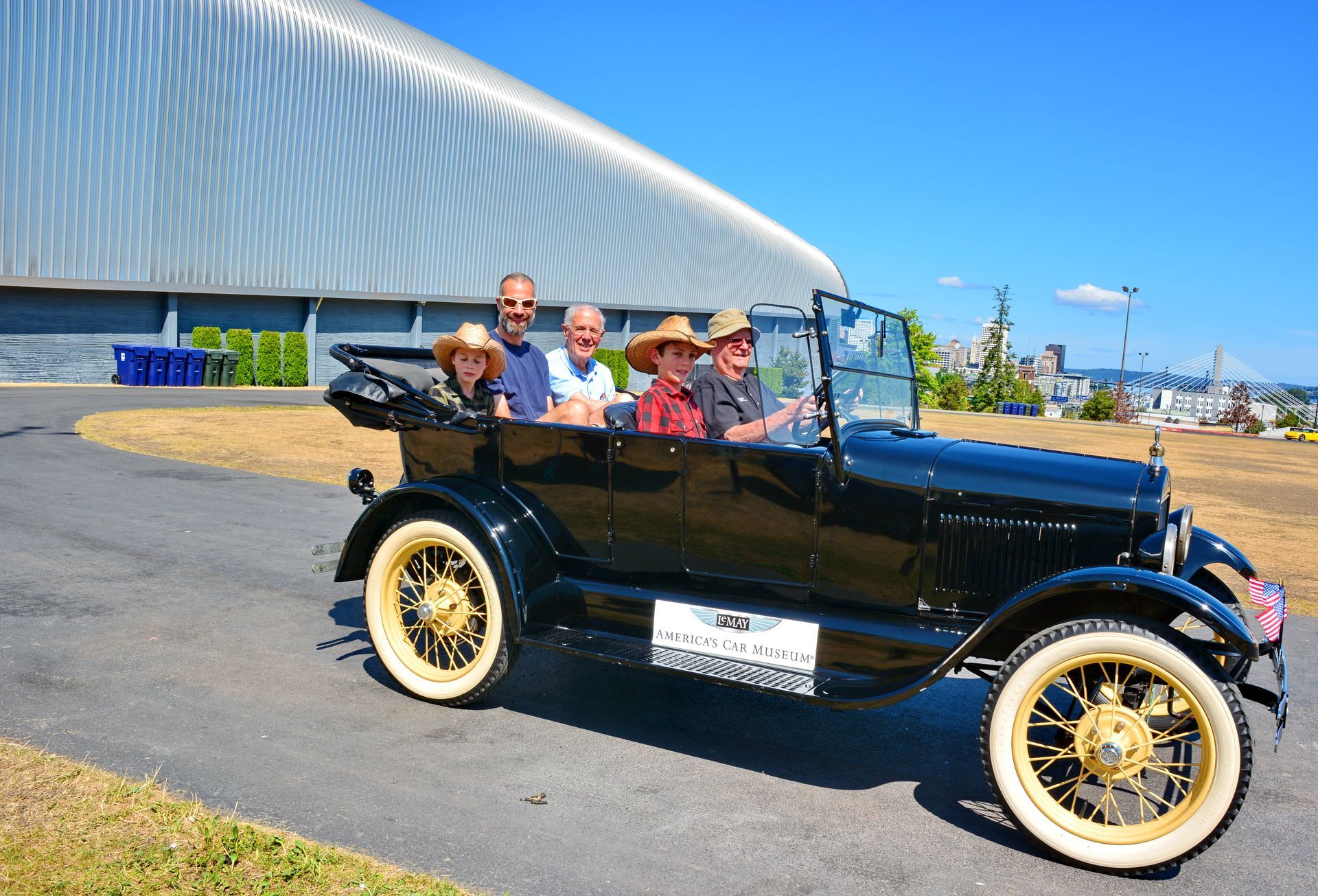 A group of people are sitting in an old car